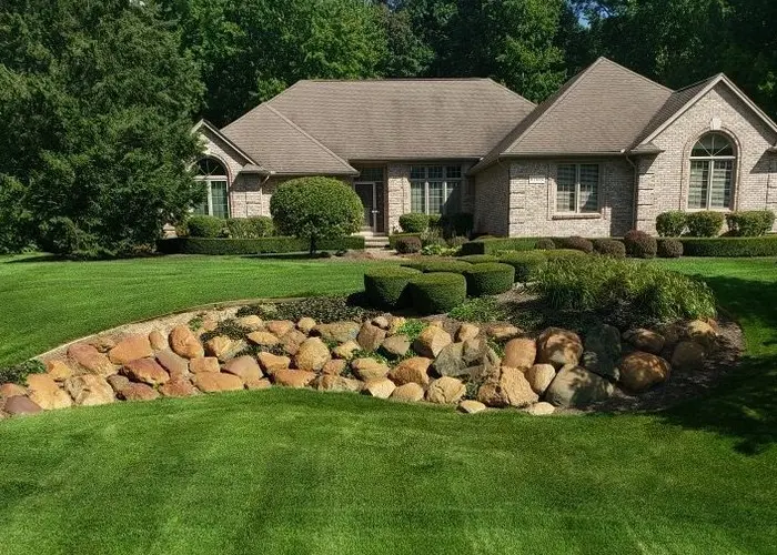 healthy green grass outside of brick home