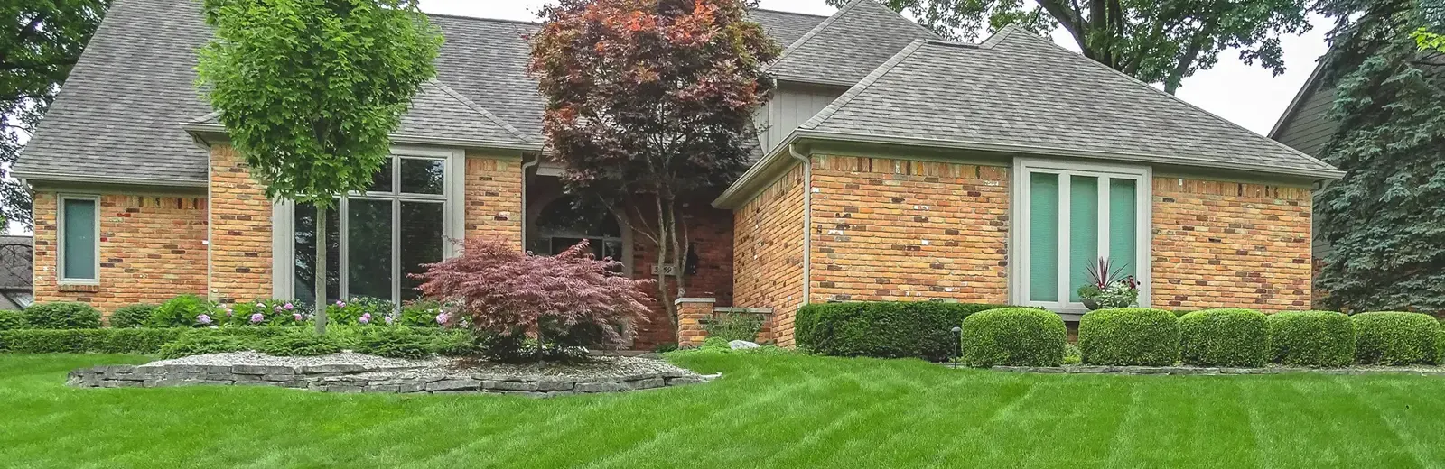 Red brick home with nice front lawn