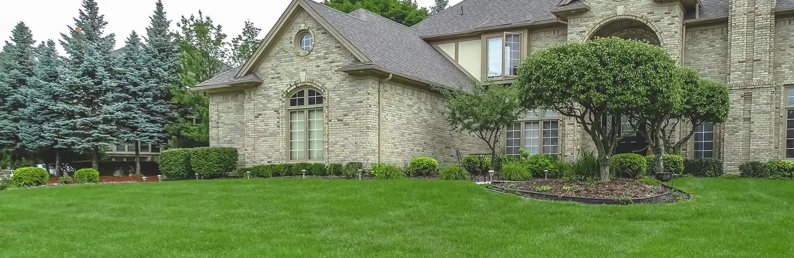 White brick home with nice front lawn