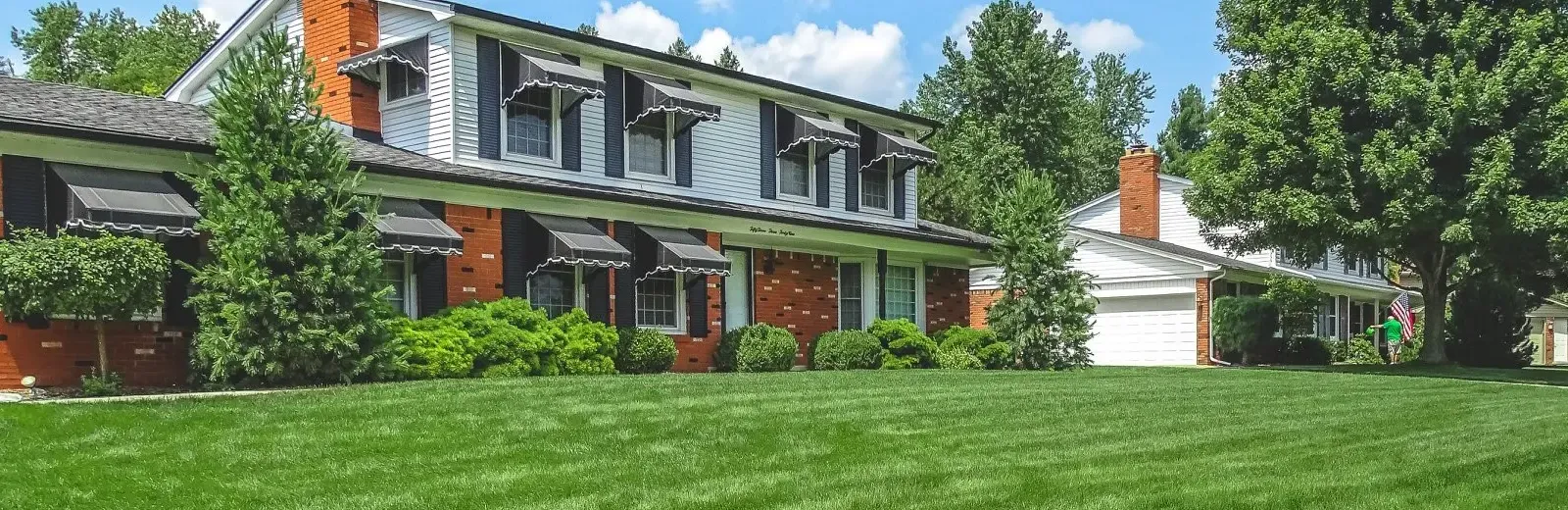 two story split level home with nice healthy front lawn